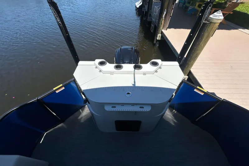 Slide: The Image of 2022 Godfrey Sweetwater 2286FS boat docked by the water. - 52