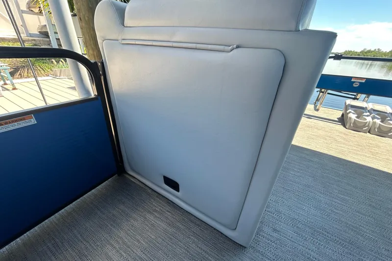 Slide: The Image of 2022 Godfrey Sweetwater 2286FS boat interior with cushioned seating and deck view. - 57