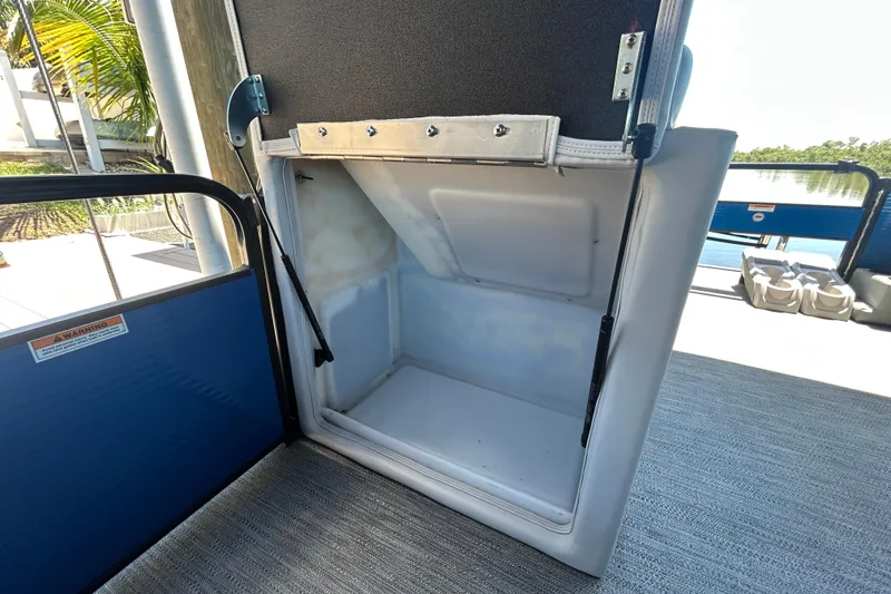Slide: The Image of Open storage compartment on 2022 Godfrey Sweetwater 2286FS pontoon boat, showcasing interior space. - 58