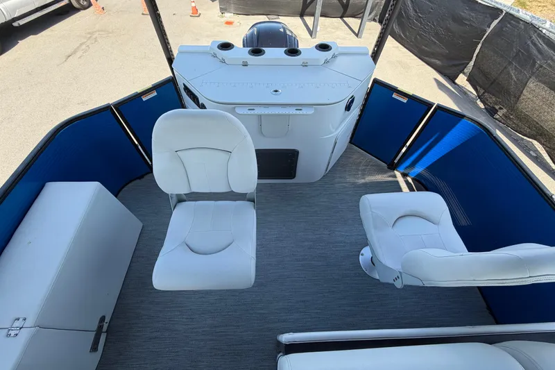 Slide: The Image of 2022 Godfrey Sweetwater 2286FS boat interior with white seating and blue paneling. - 43