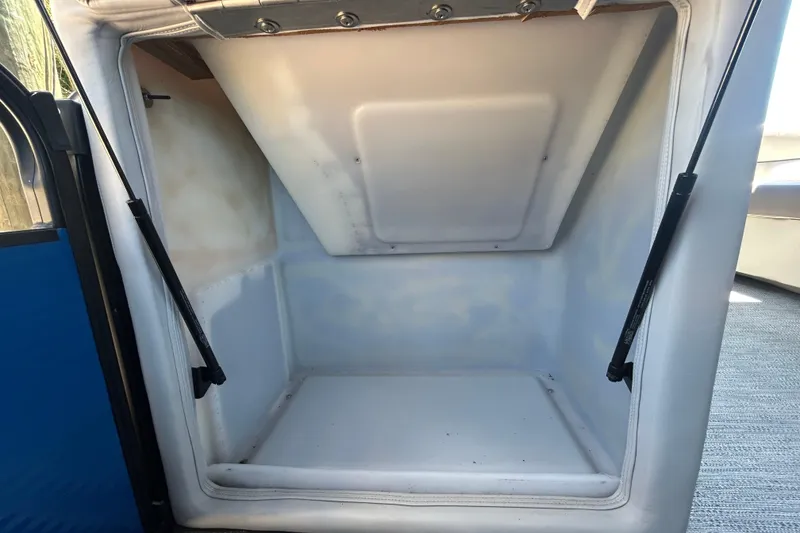 Slide: The Image of Storage compartment of 2022 Godfrey Sweetwater 2286FS boat, featuring hydraulic supports. - 59