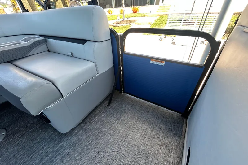 Slide: The Image of Interior of 2022 Godfrey Sweetwater 2286FS boat with gray seating and blue gate. - 60