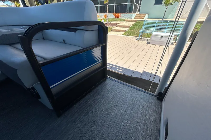 Slide: The Image of Interior view of 2022 Godfrey Sweetwater 2286FS pontoon boat with open door to deck. - 61