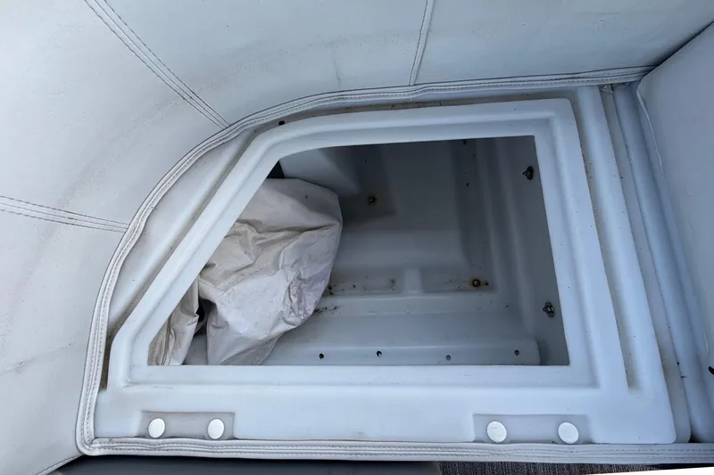 Slide: The Image of An empty storage compartment with white upholstery and a white cloth. - 40