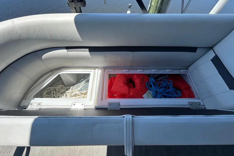 Slide: The Image of Storage compartments on a 2022 Godfrey Sweetwater 2286FS boat with ropes and life jackets. - 63