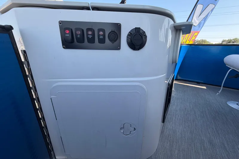 Slide: The Image of Control panel on a 2022 Godfrey Sweetwater 2286FS boat, featuring switches and outlets. - 53