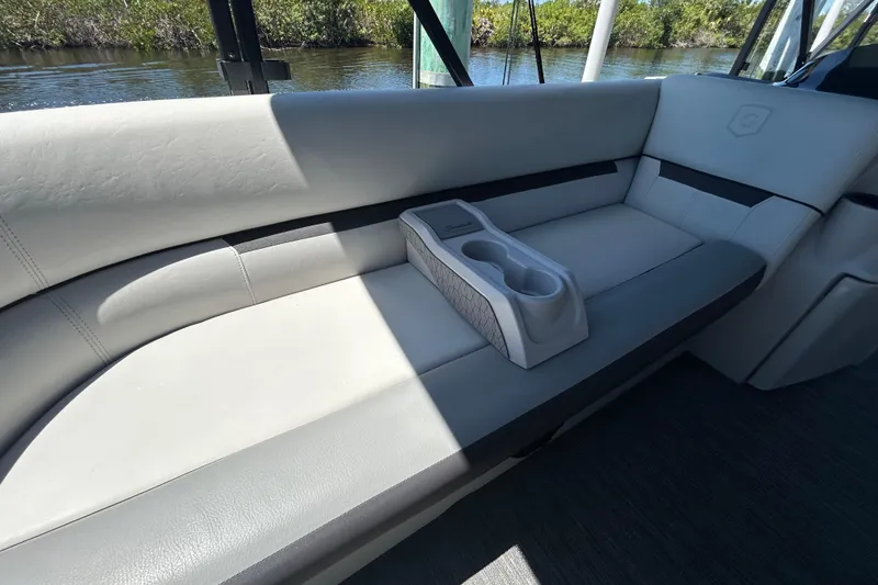 Slide: The Image of Interior seating of 2022 Godfrey Sweetwater 2286FS boat with cup holders, near water. - 66
