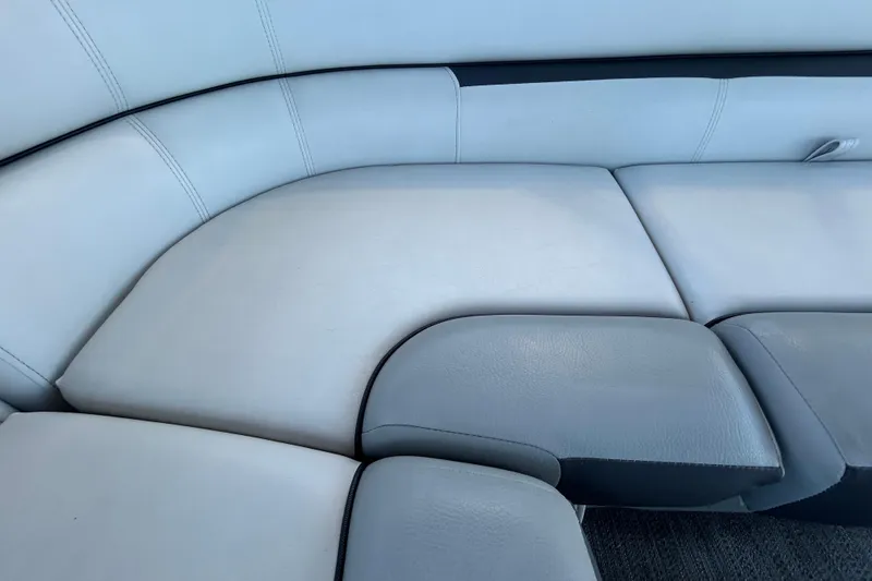 Slide: The Image of 2022 Godfrey Sweetwater 2286FS boat interior seating, featuring light gray upholstery. - 77