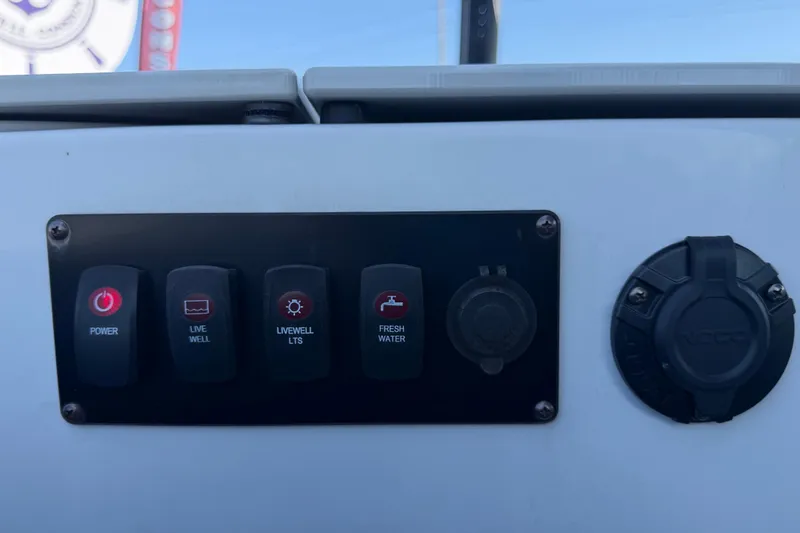 Slide: The Image of Control panel of 2022 Godfrey Sweetwater 2286FS boat with power and livewell switches. - 54