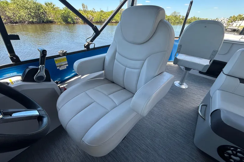Slide: The Image of Luxurious seating on 2022 Godfrey Sweetwater 2286FS pontoon boat, featuring plush captain's chair. - 83