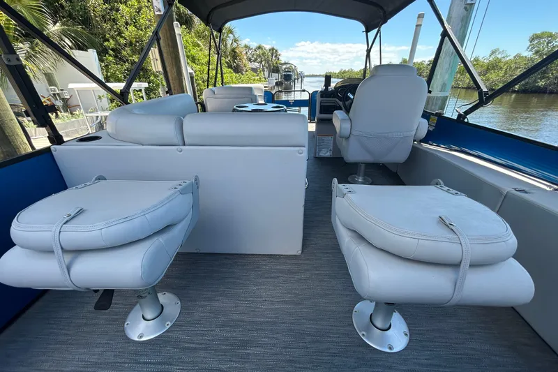 Slide: The Image of Interior of a 2022 Godfrey Sweetwater 2286FS boat with plush seating and steering console. - 87