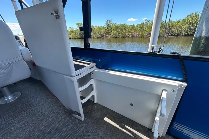 Slide: The Image of Interior view of 2022 Godfrey Sweetwater 2286FS boat with open storage compartment. - 89