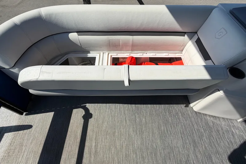 Slide: The Image of 2022 Godfrey Sweetwater 2286FS boat seat with storage compartment and life jackets. - 14
