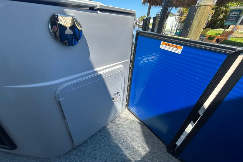 Slide: The Image of 2022 Godfrey Sweetwater 2286FS boat interior with blue gate and storage compartment. - 92