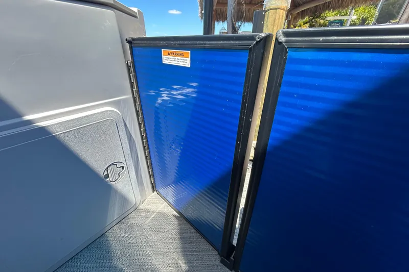 Slide: The Image of Interior view of 2022 Godfrey Sweetwater 2286FS boat with blue panel and warning label. - 93