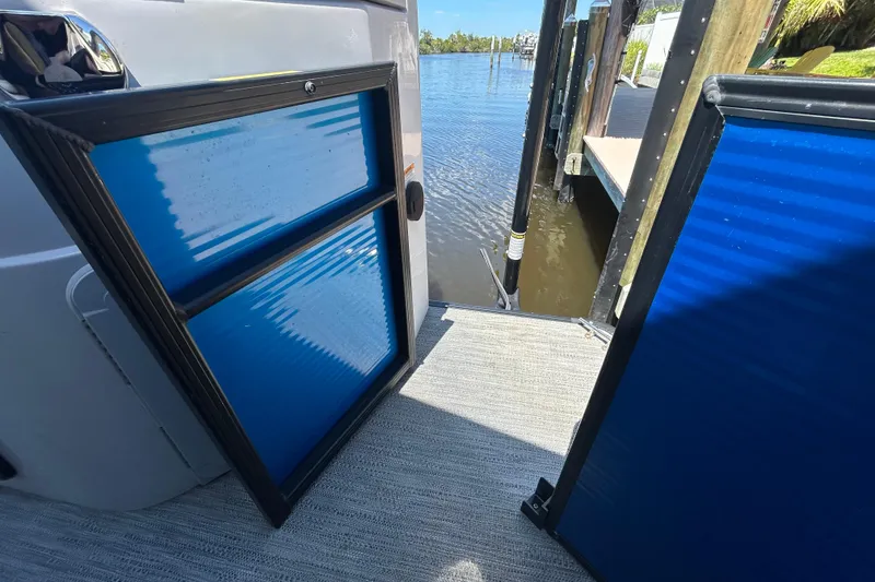 Slide: The Image of 2022 Godfrey Sweetwater 2286FS boat gate open, dockside view. - 94