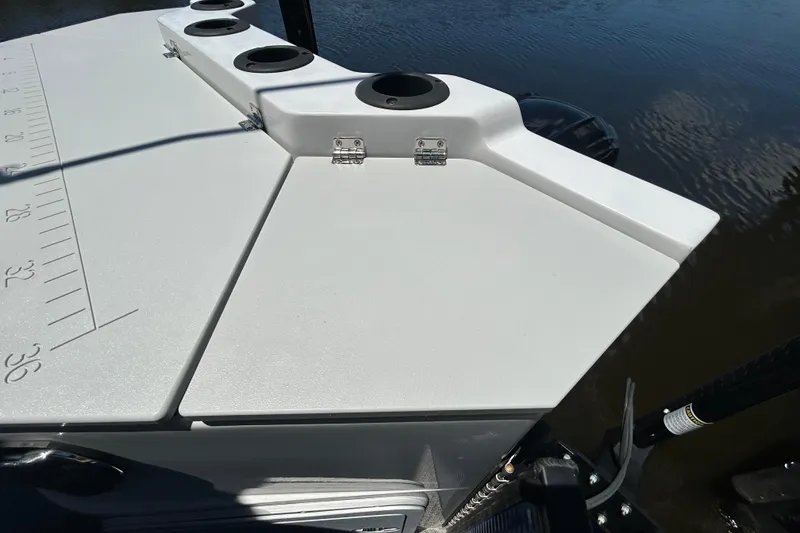 Slide: The Image of 2022 Godfrey Sweetwater 2286FS boat deck with cup holders and measurement markings. - 98