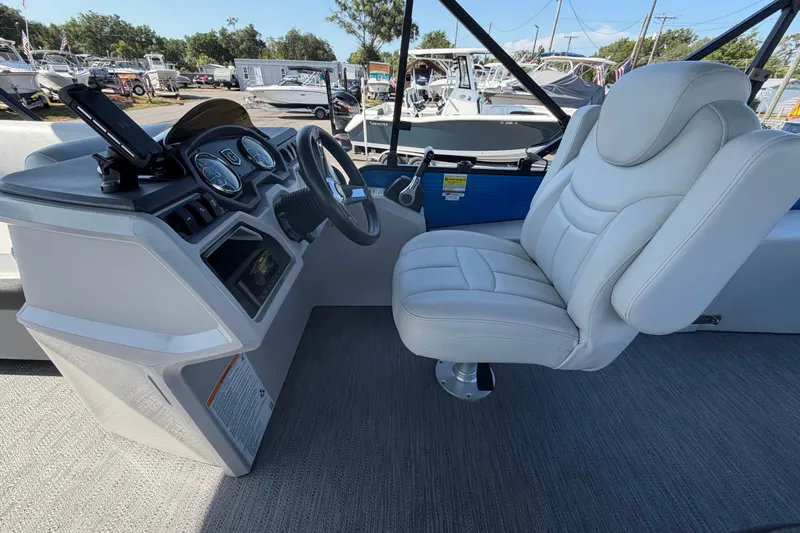 Slide: The Image of Captain's seat and helm of 2022 Godfrey Sweetwater 2286FS boat, featuring modern controls. - 25