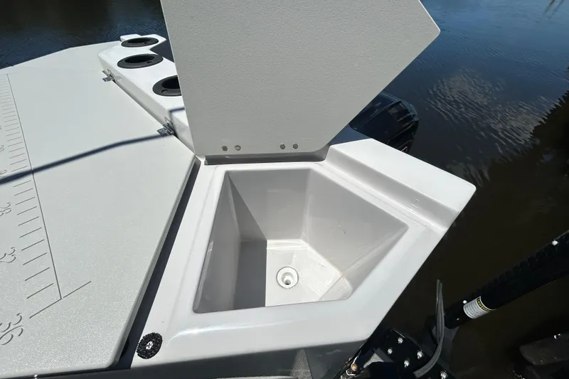 Slide: The Image of Godfrey Sweetwater 2286FS 2022 boat with open storage compartment near water. - 99