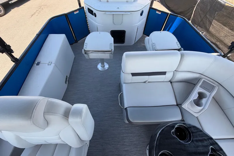 Slide: The Image of Interior of a Godfrey Sweetwater 2286FS pontoon boat with white seating and table. - 42