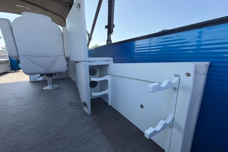 Slide: The Image of 2022 Godfrey Sweetwater 2286FS boat interior with white seating and blue paneling. - 70