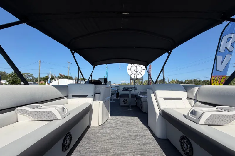 Slide: The Image of 2022 Godfrey Sweetwater 2286FS pontoon boat interior with spacious seating and canopy. - 12