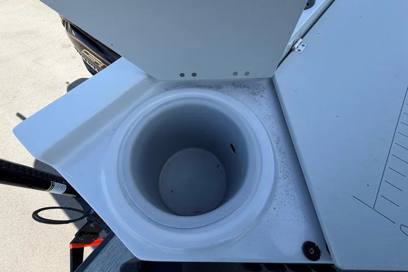 Slide: The Image of A round, white compartment on a boat, possibly a livewell or storage space. - 49
