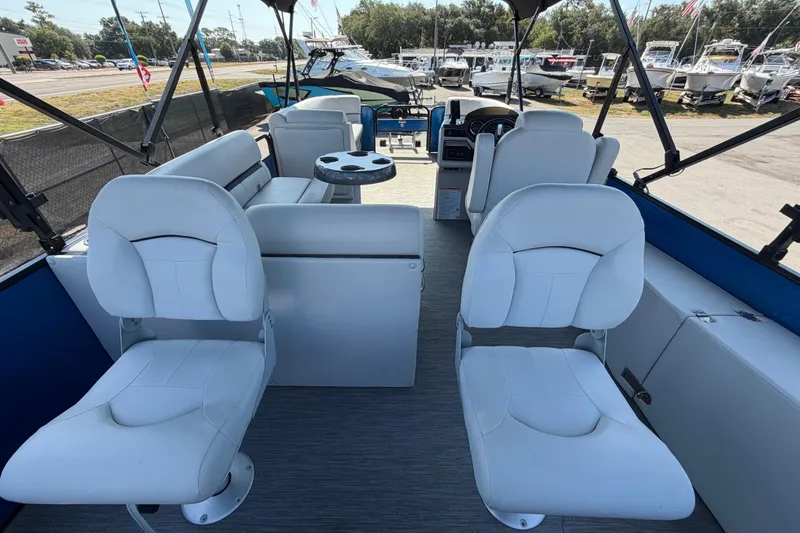 Slide: The Image of 2022 Godfrey Sweetwater 2286FS pontoon boat interior with white seating and table. - 67