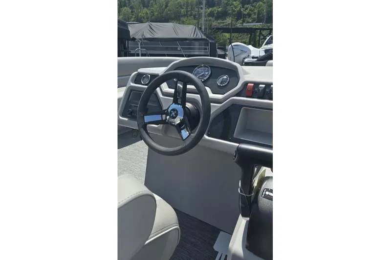 Slide: The Image of Steering console of 2025 Godfrey EX 2086 SBX boat, featuring modern controls and gauges. - 3