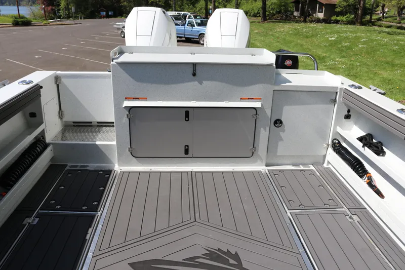 Slide: The Image of 2026 KingFisher 3425 GFX Offshore boat deck with storage compartments and twin engines. - 24