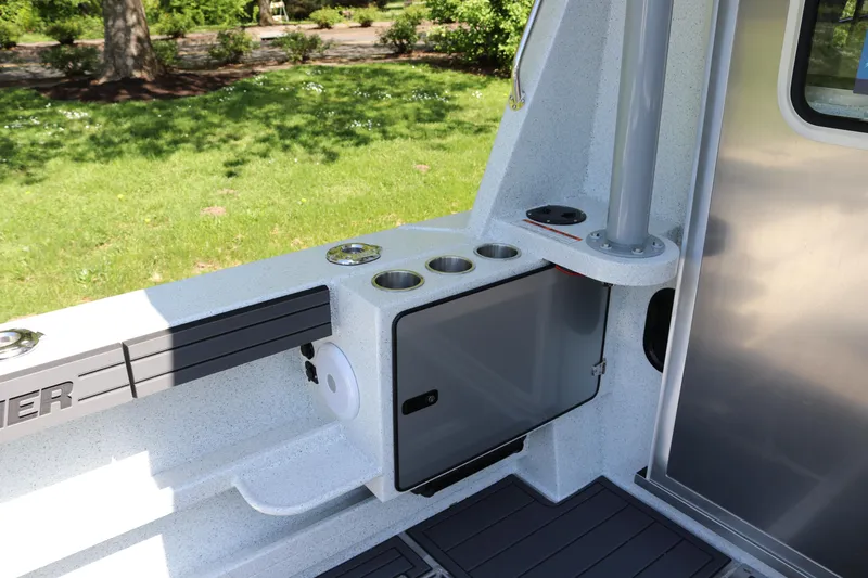 Slide: The Image of Interior view of 2026 KingFisher 3425 GFX Offshore boat, featuring storage and cup holders. - 27