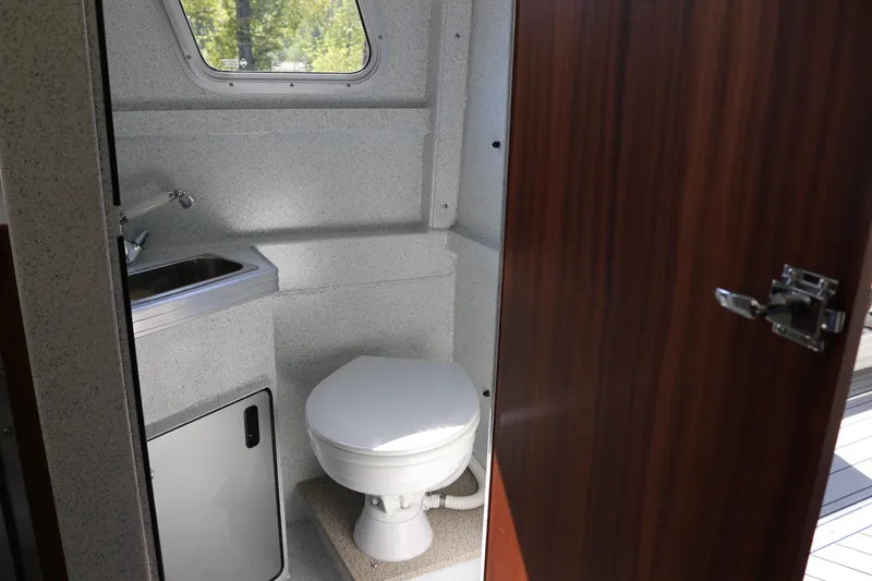 Slide: The Image of Compact bathroom in 2026 KingFisher 3425 GFX Offshore boat with sink and toilet. - 19