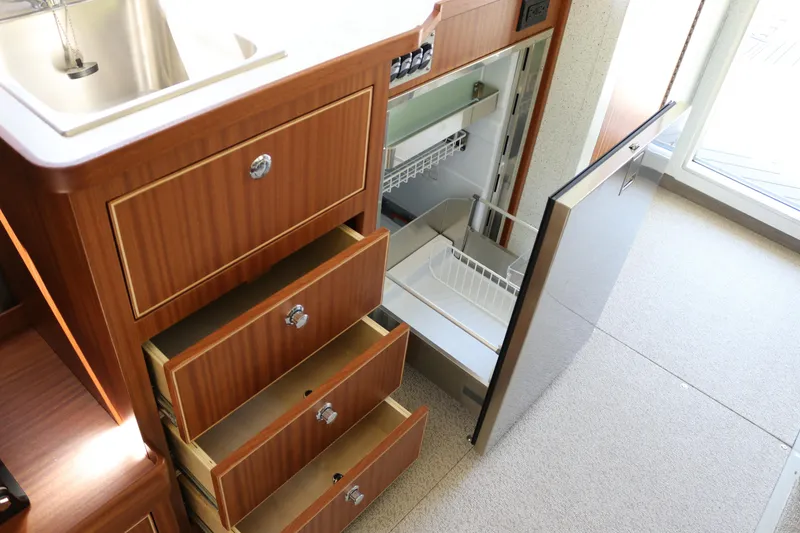 Slide: The Image of Interior of 2026 KingFisher 3425 GFX Offshore with open drawers and fridge. - 15