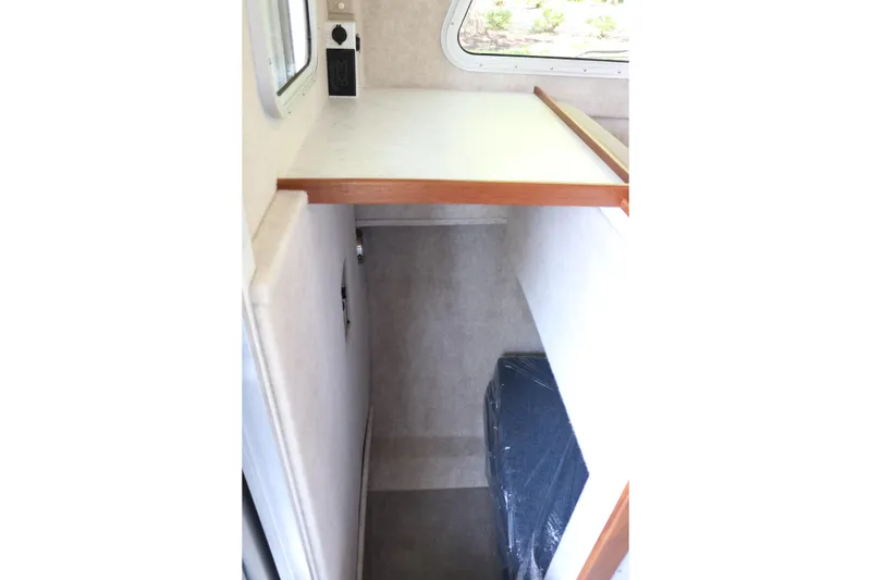 Slide: The Image of Interior cabin view of 2026 KingFisher 3425 GFX Offshore boat, featuring compact sleeping area. - 17