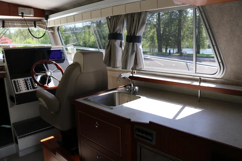 Slide: The Image of Interior of 2026 KingFisher 3425 GFX Offshore boat with helm and kitchenette. - 11