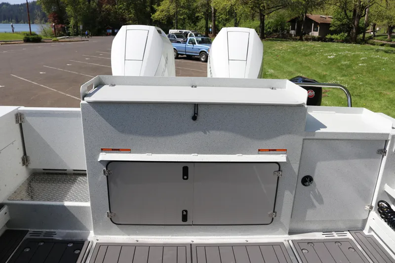 Slide: The Image of Rear view of 2026 KingFisher 3425 GFX Offshore boat with dual engines in a parking area. - 30