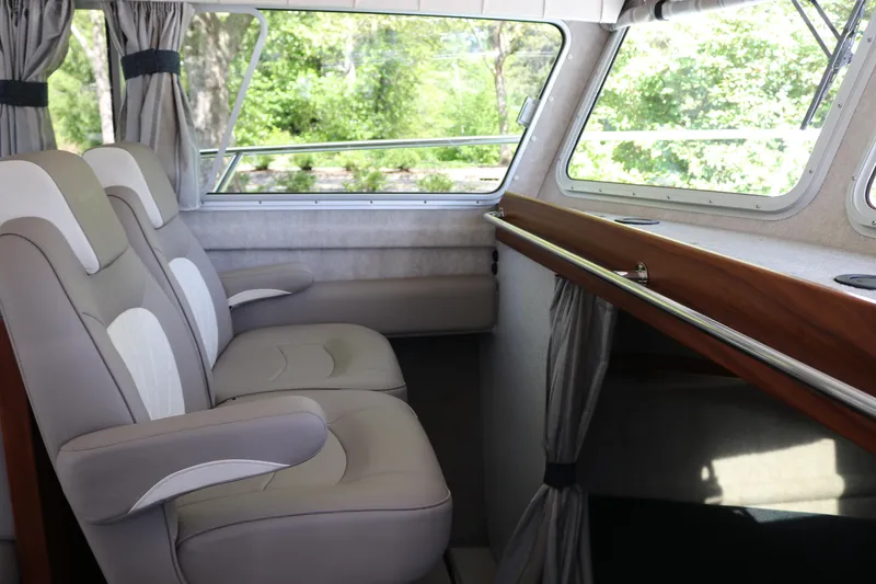 Slide: The Image of Interior of 2026 KingFisher 3425 GFX Offshore boat with comfortable seating and large windows. - 8