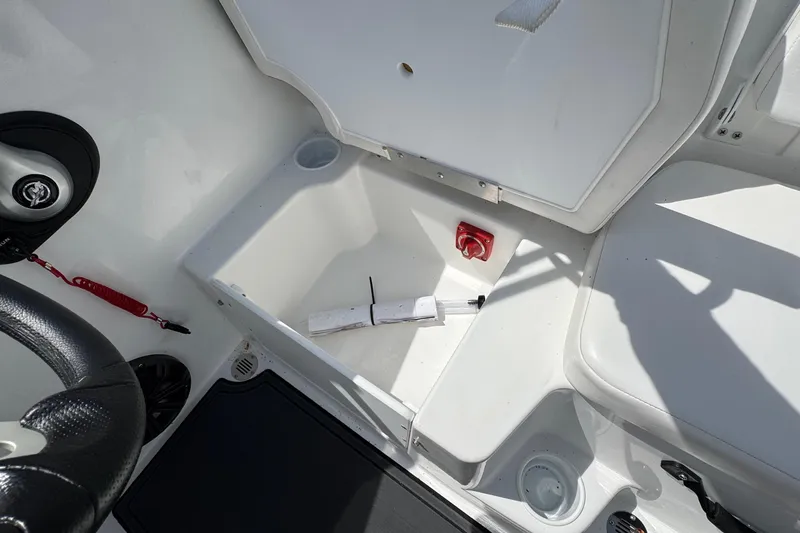 Slide: The Image of Interior view of 2025 Tahoe T18 boat storage compartment with safety features. - 14