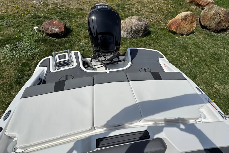 Slide: The Image of 2025 Tahoe T18 boat with outboard motor, viewed from above on grassy area. - 5