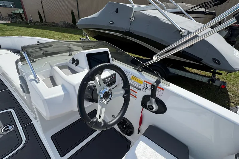 Slide: The Image of 2025 Tahoe T18 boat cockpit with steering wheel and control panel. - 8