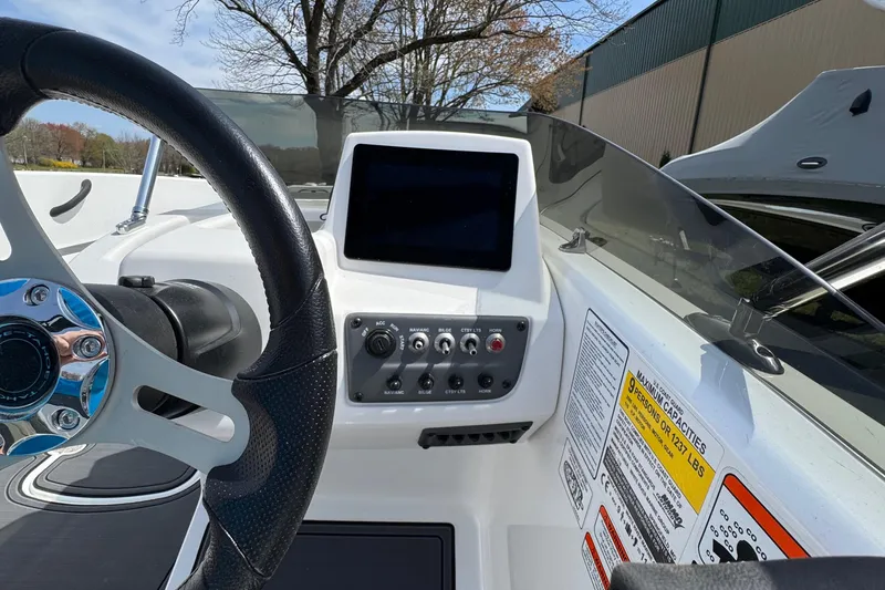 Slide: The Image of 2025 Tahoe T18 boat dashboard with steering wheel and control panel. - 9