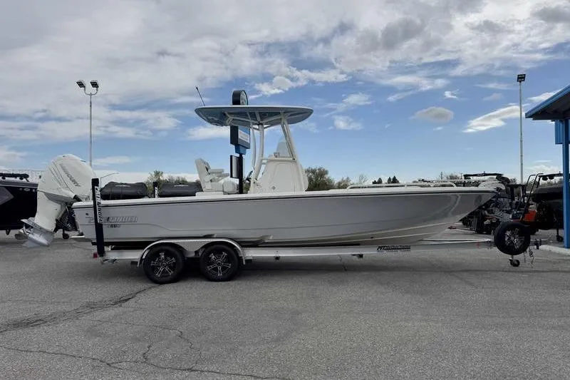 Slide: The Image of 2023 Pathfinder 2600 HPS boat on trailer under cloudy sky. - 10