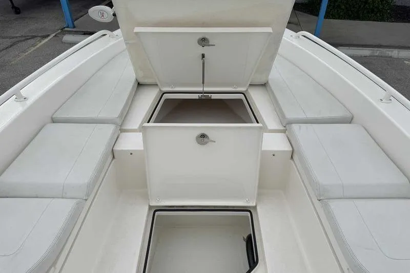 Slide: The Image of 2023 Pathfinder 2600 HPS boat interior with open storage compartments and cushioned seating. - 11