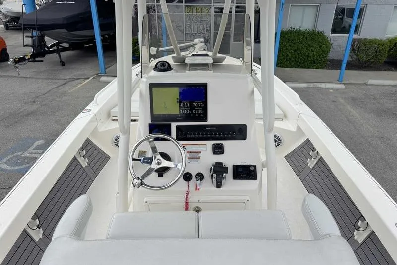 Slide: The Image of 2023 Pathfinder 2600 HPS boat cockpit with steering wheel and navigation display. - 12