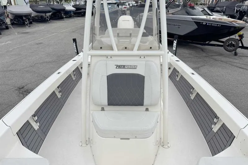Slide: The Image of 2023 Pathfinder 2600 HPS boat interior with seating and console, displayed outdoors. - 13