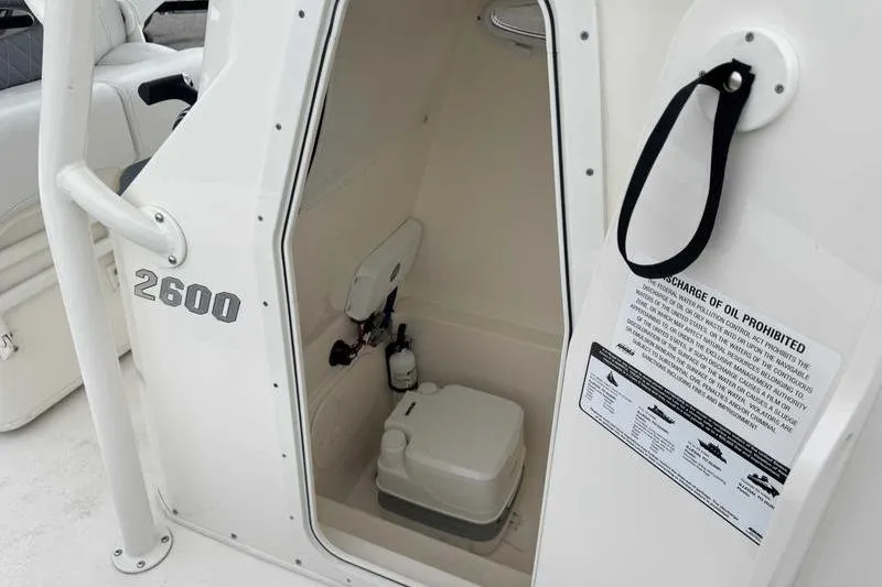 Slide: The Image of 2023 Pathfinder 2600 HPS boat interior with compact toilet and safety instructions. - 14