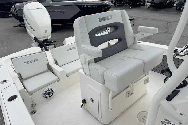Slide: The Image of 2023 Pathfinder 2600 HPS boat interior with cushioned seating and motor. - 16