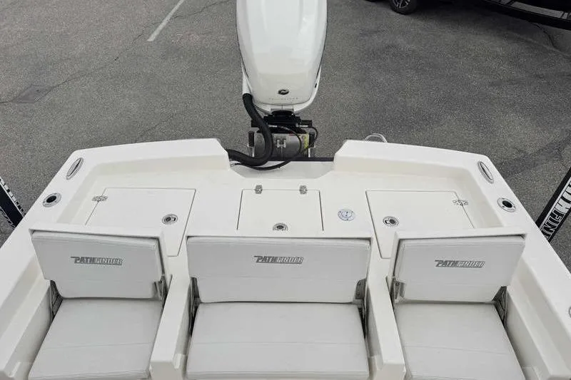 Slide: The Image of 2023 Pathfinder 2600 HPS boat with three cushioned seats and an outboard motor. - 18
