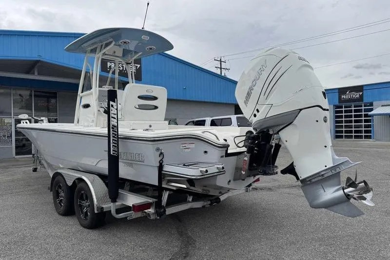 Slide: The Image of 2023 Pathfinder 2600 HPS boat with Mercury engine on trailer, parked outside dealership. - 6
