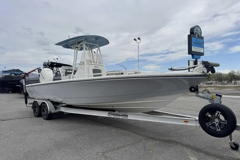 Slide: The Image of 2023 Pathfinder 2600 HPS boat on trailer in parking lot under cloudy sky. - 9
